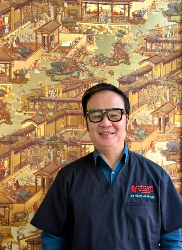 Dr Kevin Duong — Clinic Director, wearing Bao An Tang tunic
