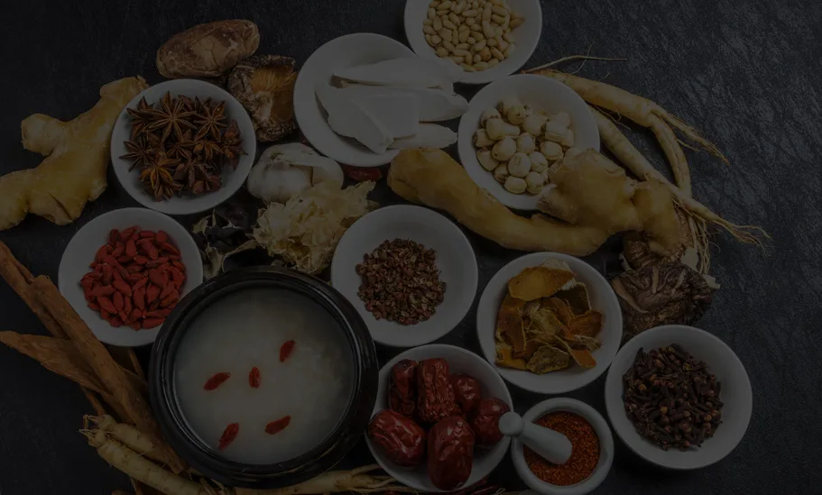 Overhead spread of TCM herbs — ginseng, goji and congee